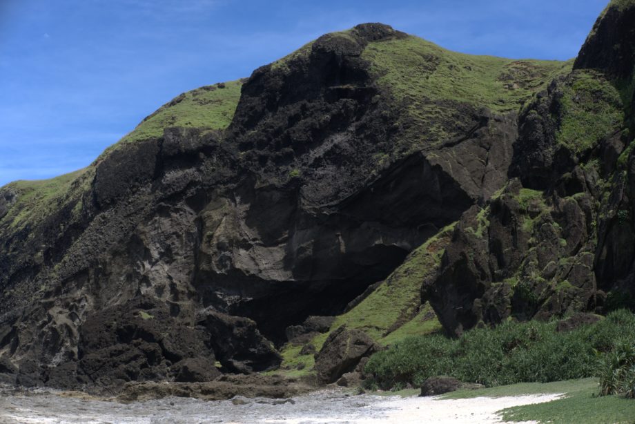 The entrance of Swallow Cave, located in the shadowy part of the hill shown in the picture