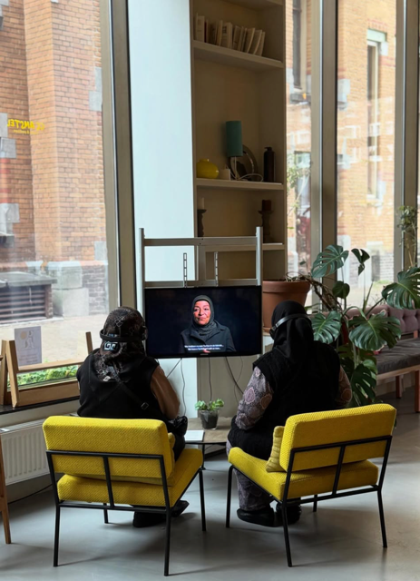 From Living Archive project, two ladies watching a video installation